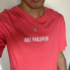 Salmon pink OBEY WORLDWIDE logo white text short sleeve t-shirt.
